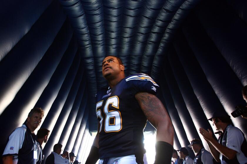 Shawne Merriman prepares to step onto the field before a San Diego Chargers-Seattle Seahawks game in San Diego.