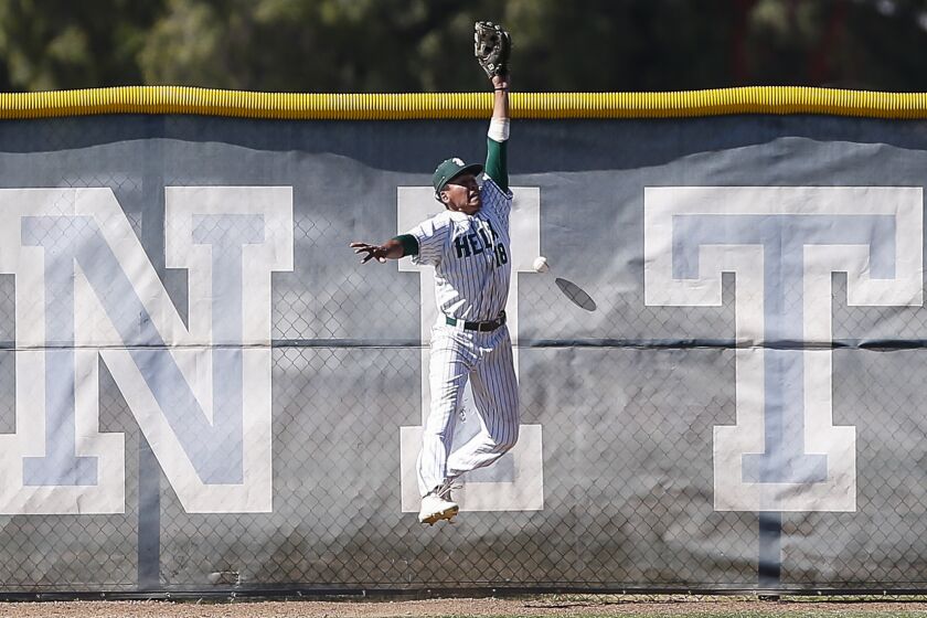 SAN DIEGO, April 18th, 2019 | 2019 Lions Tournament high school baseball Open Division championship between Helix and Desert Oasis (Nevada) on Thursday, April 18th, 2019 at Granite Hills High School in El Cajon, CA. Helix left fielder Justin Cervantes can't make a catch as the ball bounces off the fence during the start of a 13 run third inning for Desert Oasis. Photo by Chadd Cady
