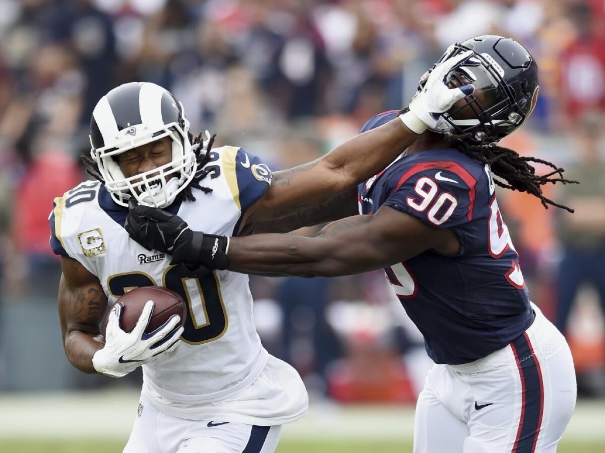 Rams running back Todd Gurley straight-arms Houston Texans linebacker/defensive end Jadeveon Clowney during a Nov. 12 game at the Coliseum.
