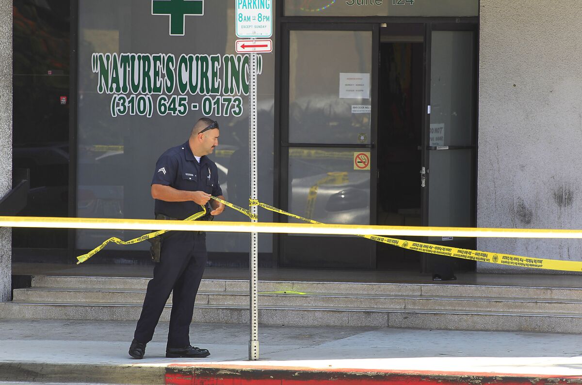 Police investigate a shooting at 5300 W. Century Boulevard near LAX. The shooting occurred during an attempted robbery of a medical marijuana dispensary.
