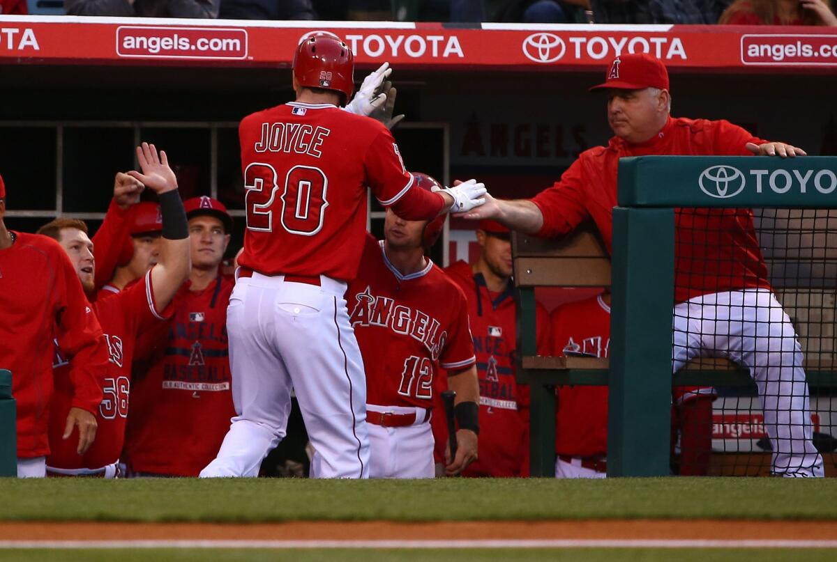 Angels left fielder Matt Joyce is congratulated by Manager Mike Scioscia after hitting a solo home run against the Tigers in the second inning Thursday night.