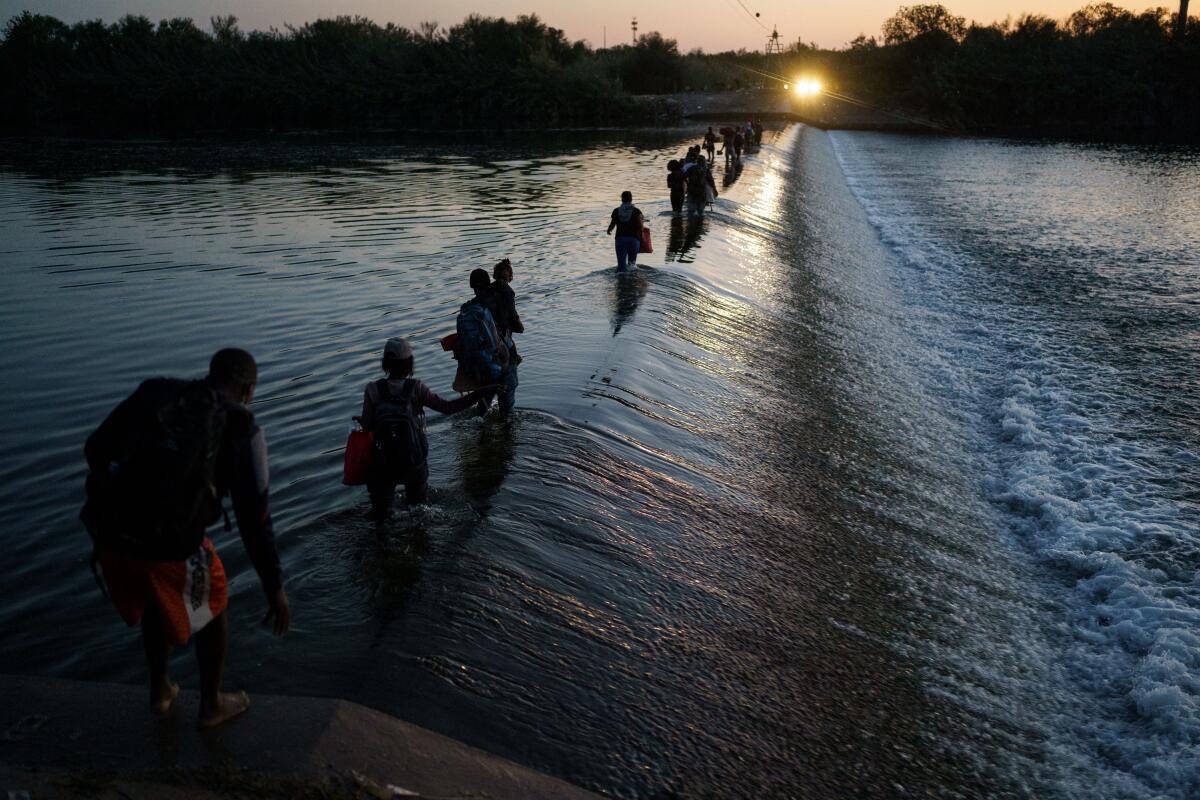 Haitian migrants cross the Rio Grande on September 18, 2021.