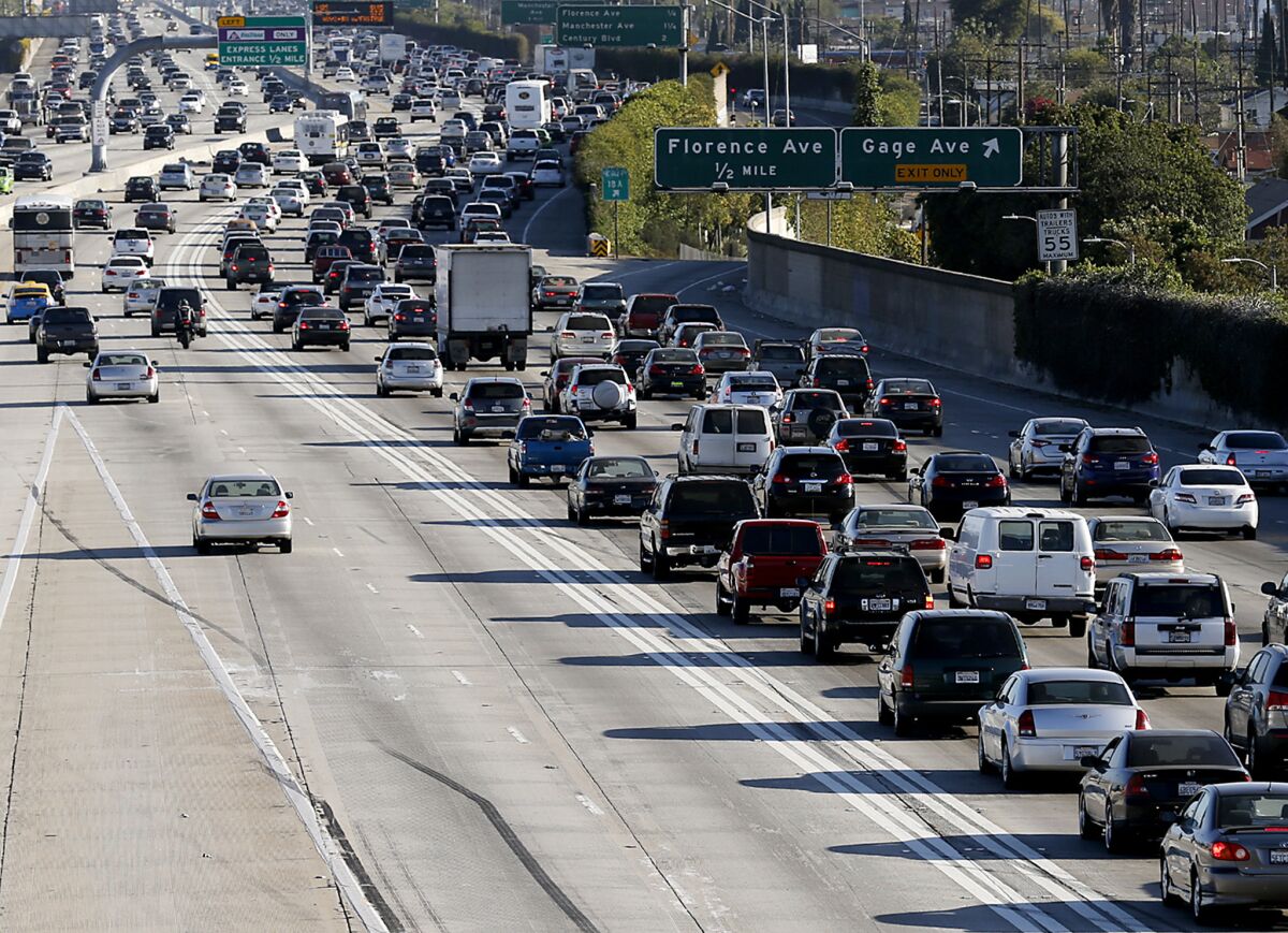 Cars, and one lone motorcyclist, take advantage of the FasTrak lanes on the 110/Harbor Freeway.