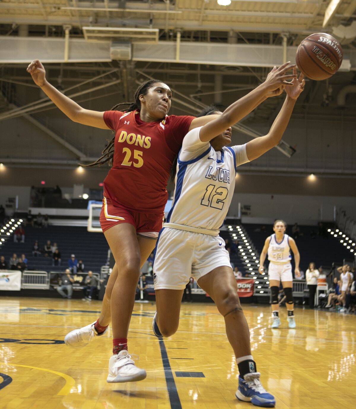 Cathedral Catholic’s Ice Brady (left) and La Jolla Country Day’s Te-hina Paopao battle for the basketball.