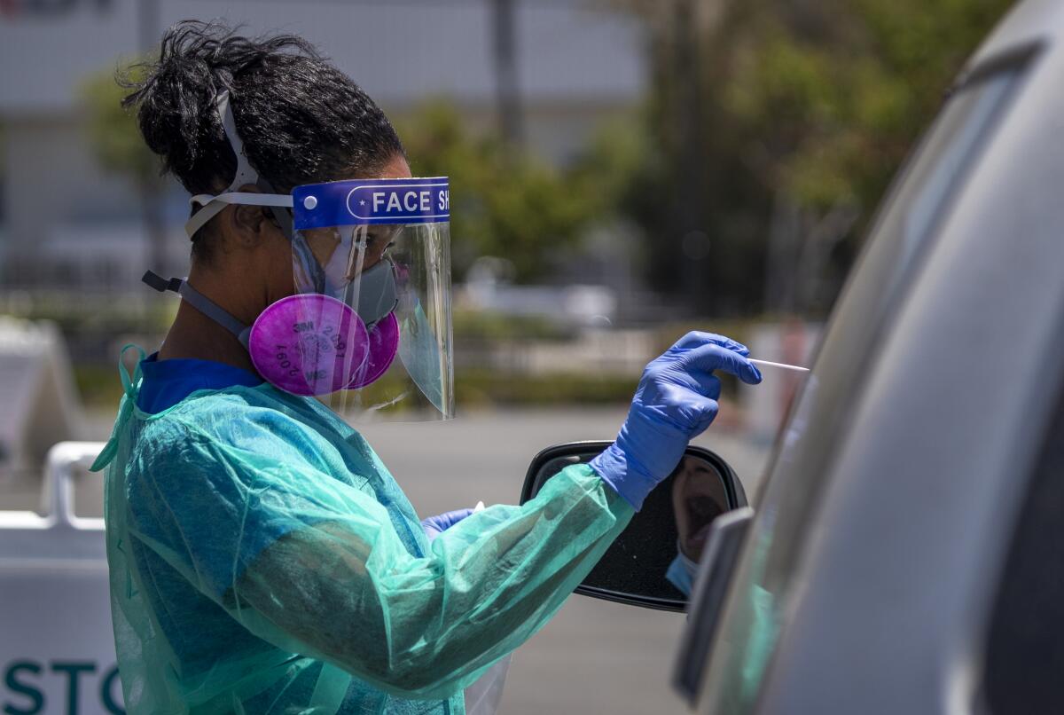 Nurse Maritza Perez giving a COVID-19 test to a patient at AltaMed Health Services in Anaheim on July 9.