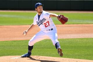 Dodgers pitcher Trevor Bauer throws a pitch against the Rockies during a spring training game in Glendale.