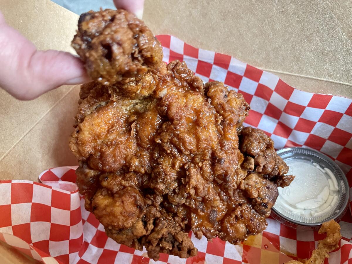 The bone-in fried chicken with a side of ranch dressing.