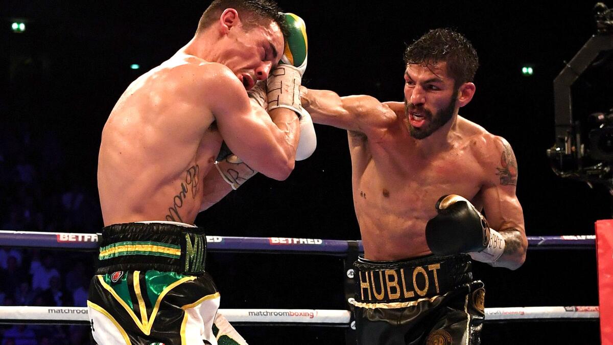 Anthony Crolla tries to block an overhand right by Jorge Linares during their WBA lightweight title fight on Saturday. (Paul Ellis / AFP/Getty Images)