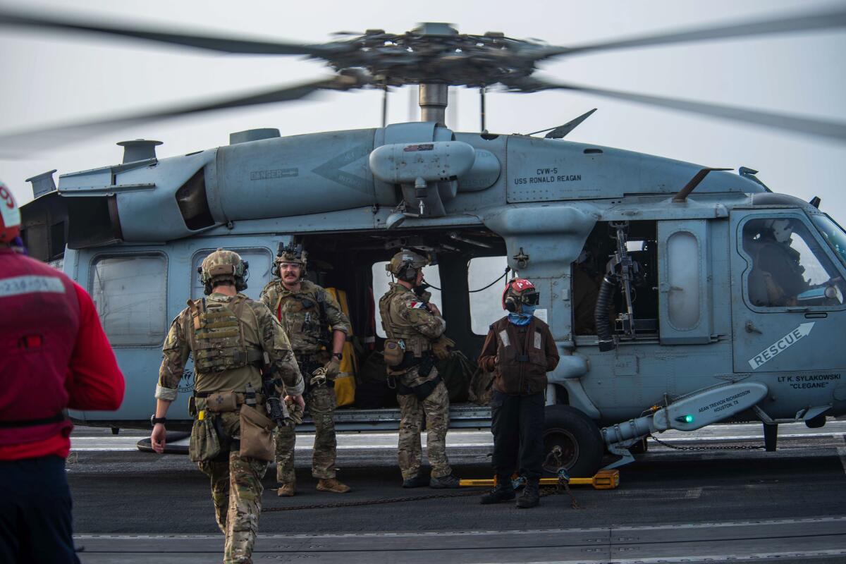 U.S. soldiers at a helicopter