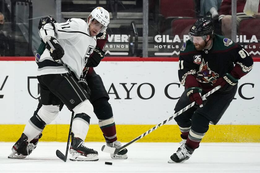 Arizona Coyotes right wing Phil Kessel (81) takes the puck from Los Angeles Kings center Anze Kopitar (11) during the third period of an NHL hockey game, Monday, May 3, 2021, in Glendale, Ariz. The Kings defeated the Coyotes 3-2. (AP Photo/Ross D. Franklin)