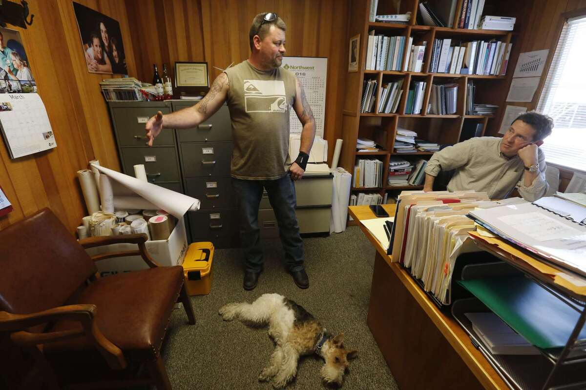 Keven Jones talks with his former boss, mill owner Linc Phillippi, a month after being let go.