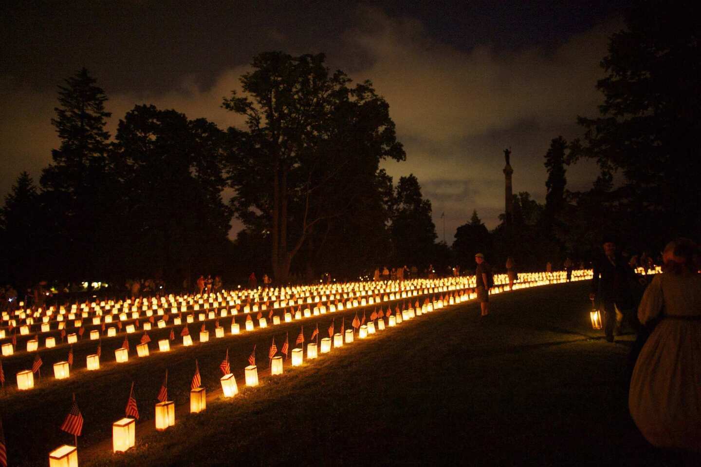 Visitors attend the Memorial Luminaria at the Soldiers' National Cemetery during events marking the 150th anniversary of the Battle of Gettysburg, in Gettysburg, Pennsylvania