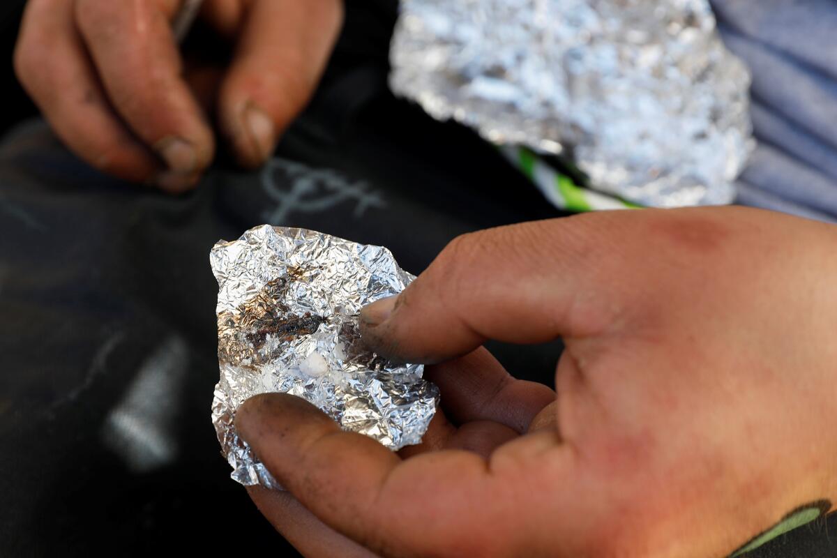 A man displays what he claims to be the synthetic drug fentanyl.