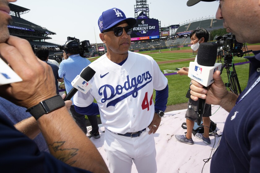 National League manager Dave Roberts, of the Los Angeles Dodgers, talks with the media during warms-ups for the MLB All-Star baseball game, Monday, July 12, 2021, in Denver. (AP Photo/David Zalubowski)