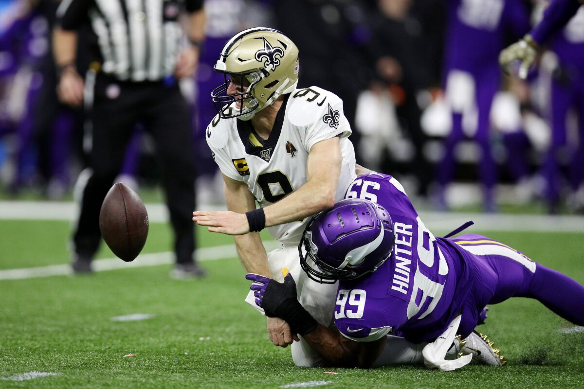 New Orleans Saints quarterback Drew Brees fumbles the ball as he is sacked by Minnesota Vikings defensive end Danielle Hunter in the fourth quarter Sunday.