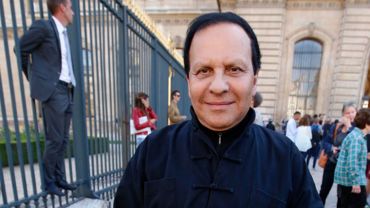 Tunisian-born fashion designer Azzedine Alaia arrives at a fashion event in Paris, on Sept. 26, 2014. The French Haute Couture Federation announced Alaia's death on Nov. 18, 2017. He was 77.