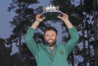 Jon Rahm holds up the trophy after winning the Masters golf tournament at Augusta National Golf Club.