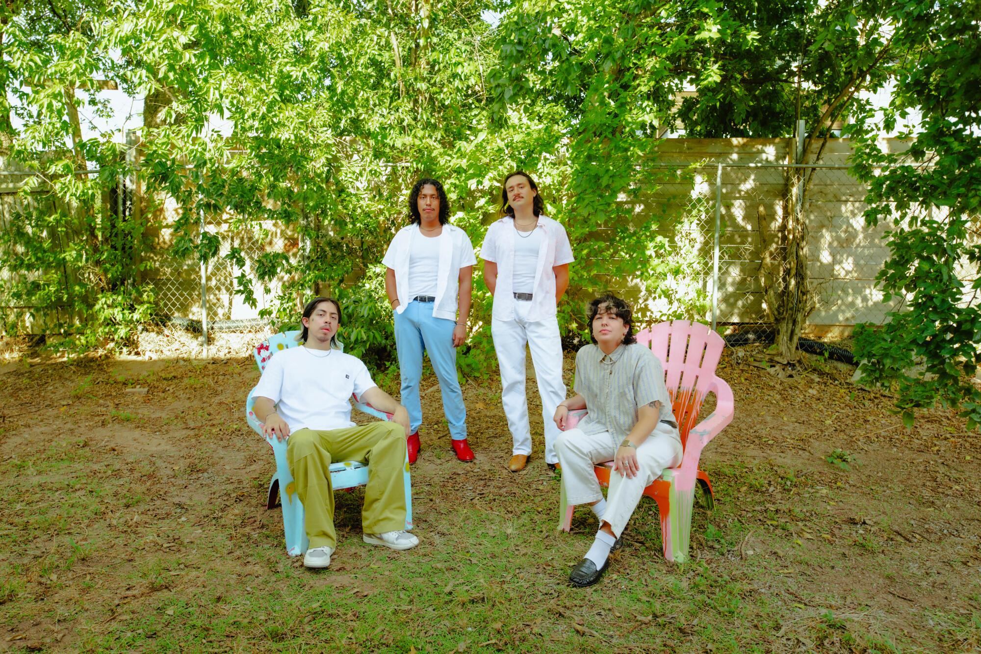 Members of Luna Luna are shown sitting and standing in their backyard in Austin, Texas.
