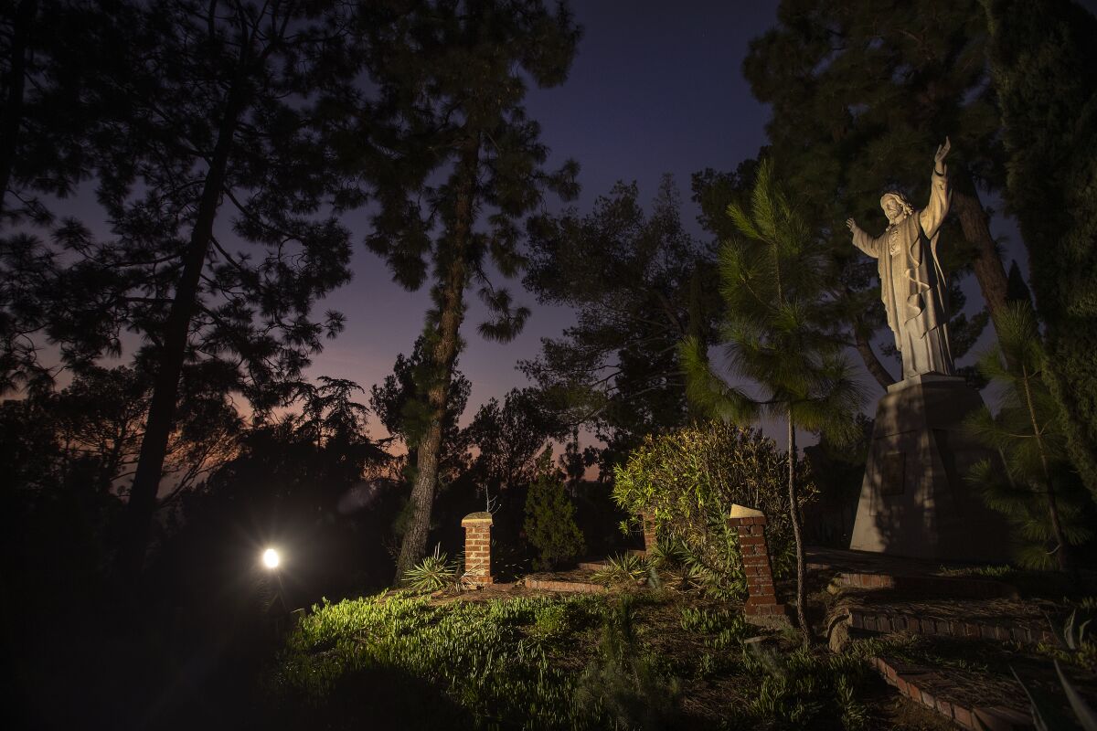 A statue of Jesus is illuminated at night on the grounds of the Monastery of the Angels in Hollywood. 