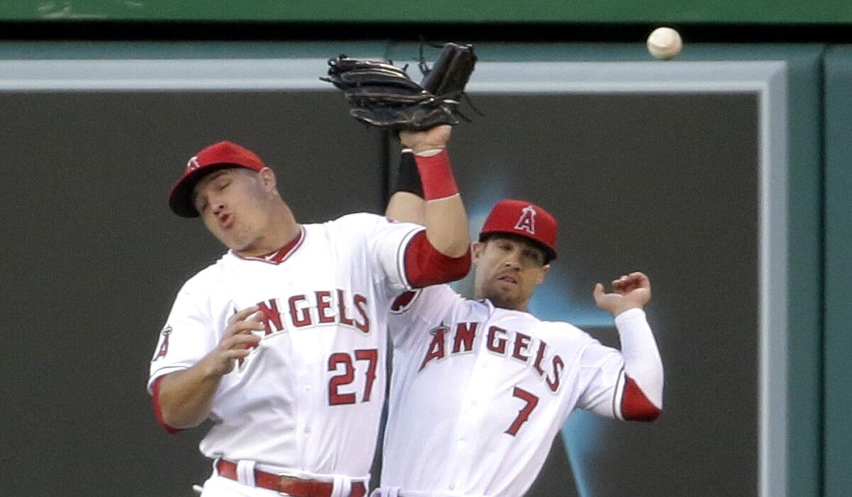 Angels center fielder Mike Trout (27) and right fielder Collin Cowgill (7) collide while trying to catch a fly ball hit by Yankees shortstop Derek Jeter in the first inning Wednesday night in Anaheim.
