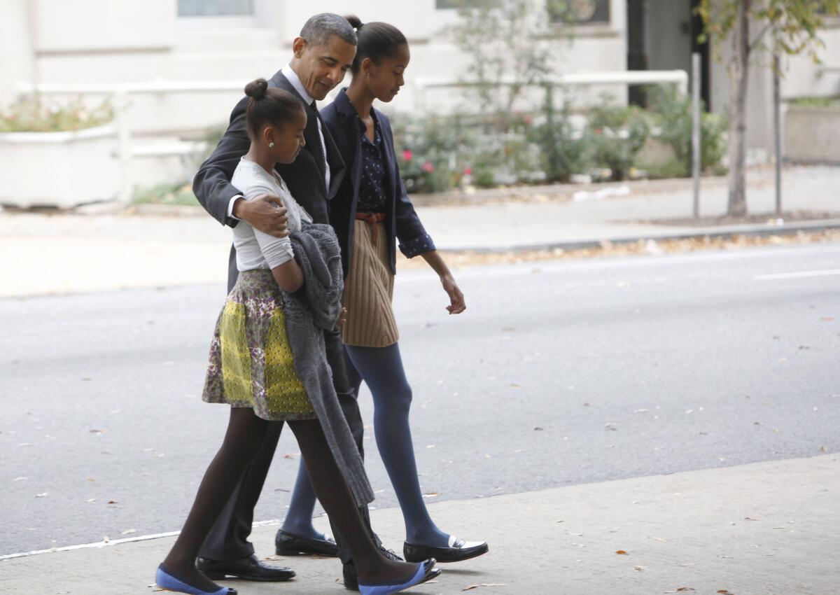 President Obama walks to the White House with his daughters Sasha and Malia earlier this year.
