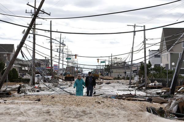 Robert Bryce, right, walks with his wife, Marcia, on Route 35 in Seaside Heights, N.J., in the immediate aftermath of Superstorm Sandy.