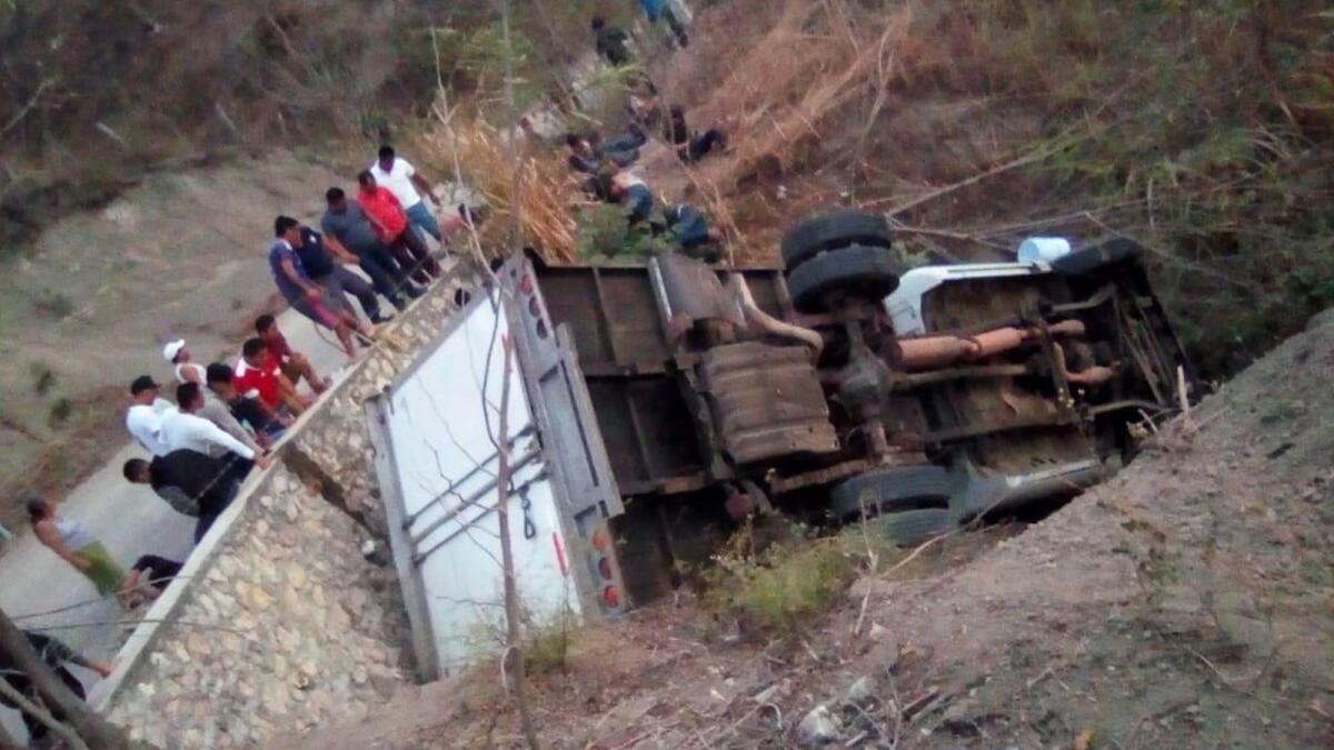 A truck that carried Central American migrants lies overturned off the Ixtapa-Soyalo highway in the state of Chiapas, Mexico.
