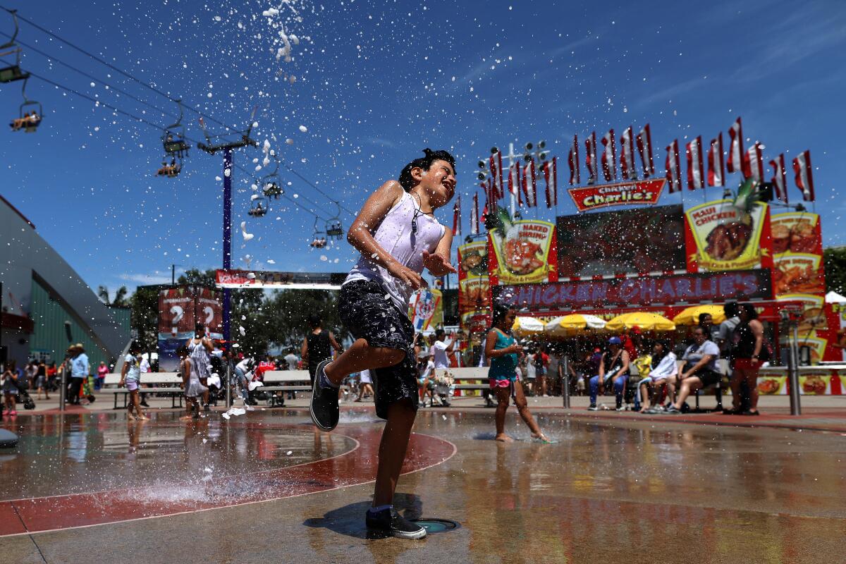 Issaiah Reynoso, of Santa Ana, tries to beat the heat in the splash pad during the 2019 Orange County Fair in Costa Mesa. The 2020 fair has been canceled.