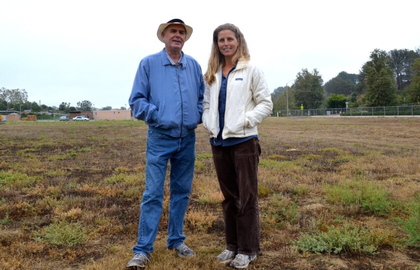 Gordon Smith and Elizabeth Taylor, organizers of the Encinitas Community Garden, stand where planter boxes will be placed. After much delay, a garden groundbreaking is slated for 10 a.m. on July 11 at 441 Quail Gardens Drive.