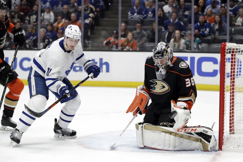 Ducks goalie John Gibson stops a shot in front of the Maple Leafs' Zach Hyman on March 6, 2020.