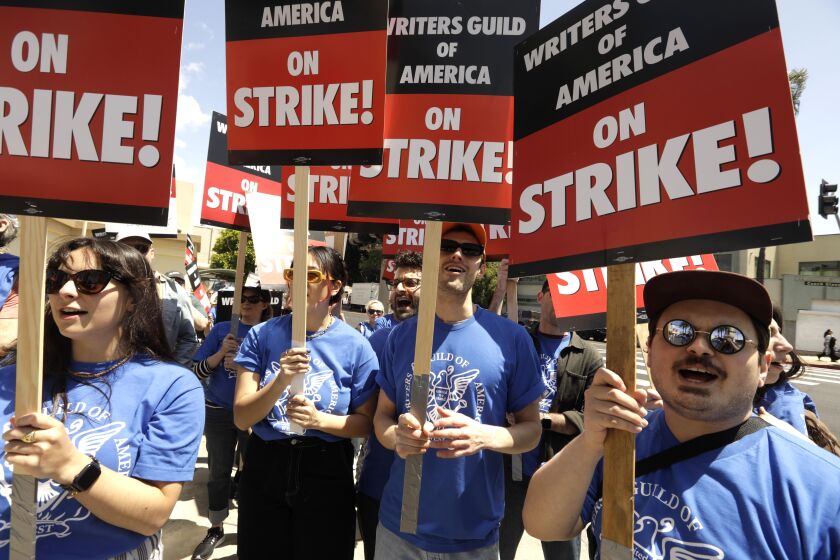 HOLLYWOOD, CA - MAY 2, 2023 - WGA members walk the picket line on the first day of their strike in front of Paramount Studios in Hollywood on May 2, 2023. The union were unable to reach a last minute-accord with the major studios on a new three-year contract to replace one that expired Monday night. (Genaro Molina / Los Angeles Times)