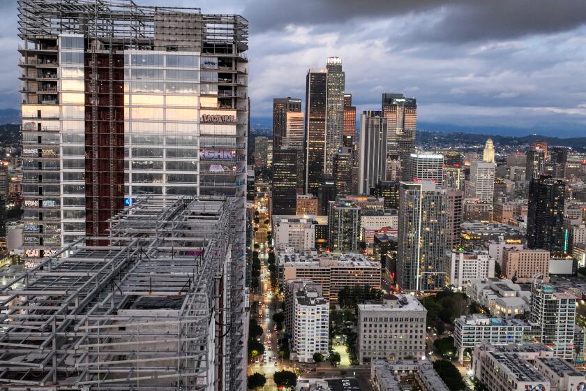 Los Angeles, CA, Thursday, February 1, 2024 - Taggers have graffitied what appears to be more than 25 stories of a downtown Los Angeles skyscraper that's been sitting dormant for several years. Construction on Oceanwide Plaza, a $1 billion mixed-use retail and luxury apartments project with three towering unfinished structures, stalled in January 2019 after the Beijing-based developer lacked the funds to complete it. (Robert Gauthier/Los Angeles Times)