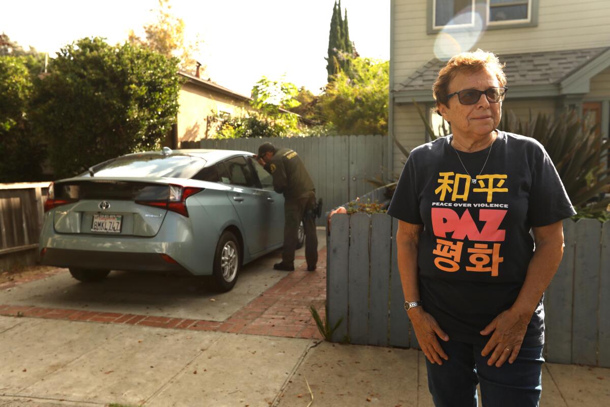 Patti Giggans outside her home during a raid by the L.A. County Sheriff's Department.