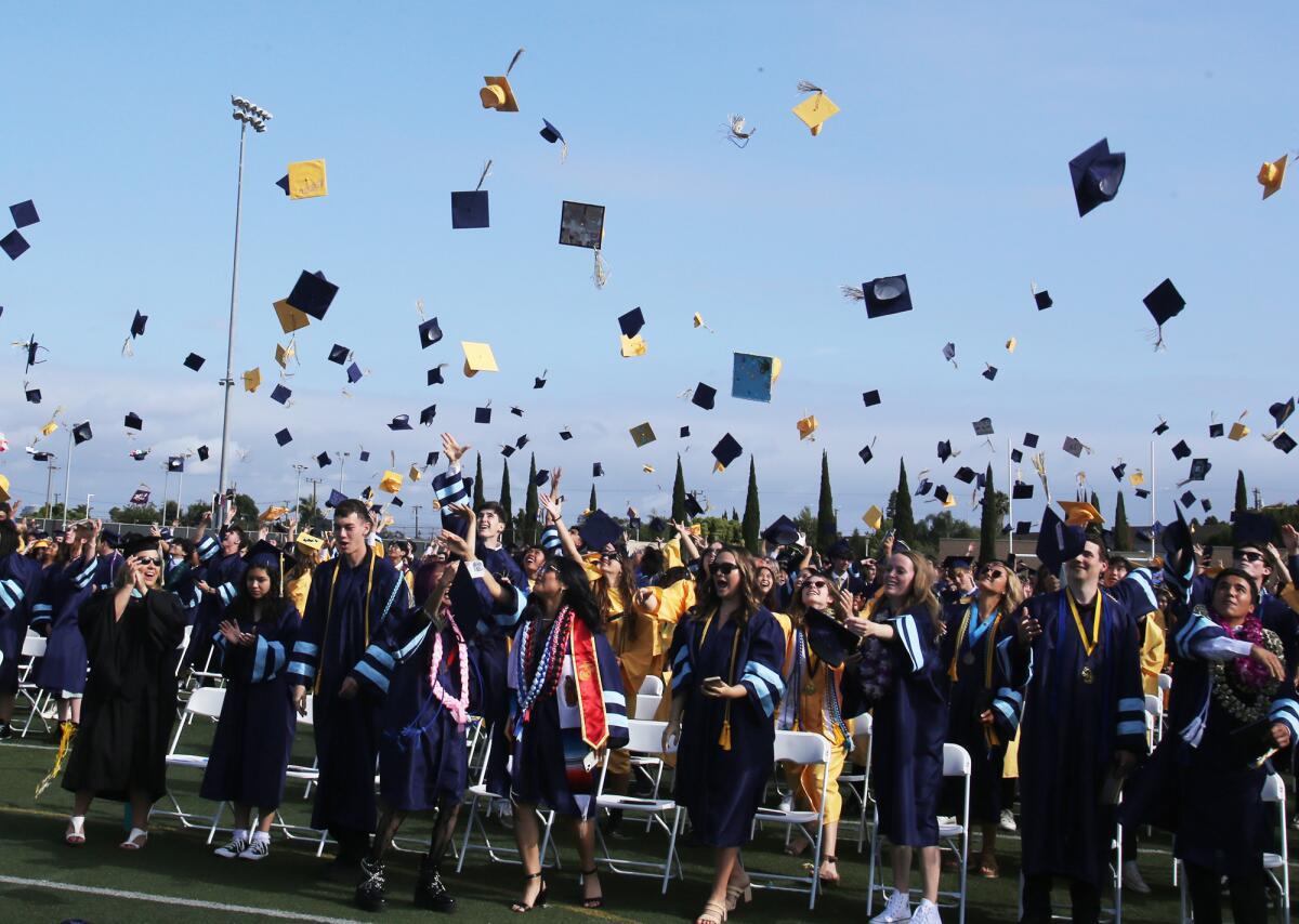 Marina High School graduates throw up their caps during the 2023 commencement ceremony on Thursday.