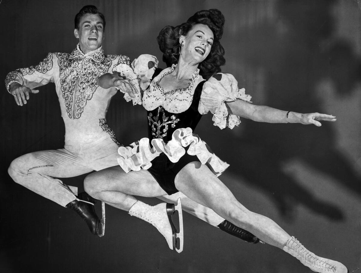 May 1951: Donna Atwood and Bobby Specht, stars of the 1951 edition of the Ice Capades, perform a "stag leap."