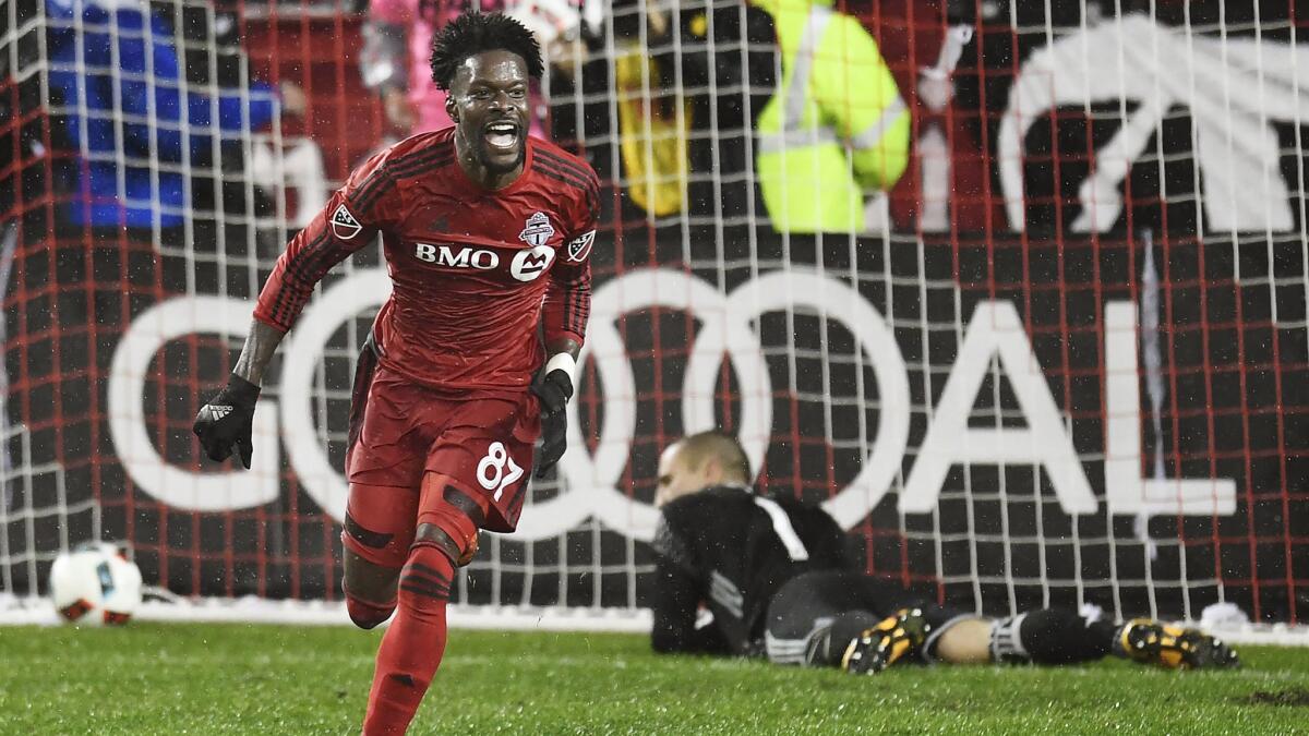 Toronto FC forward Tosaint Ricketts (87) celebrates his goal against Montreal Impact goalkeeper Evan Bush (1) during extra time in their game Wednesday night.