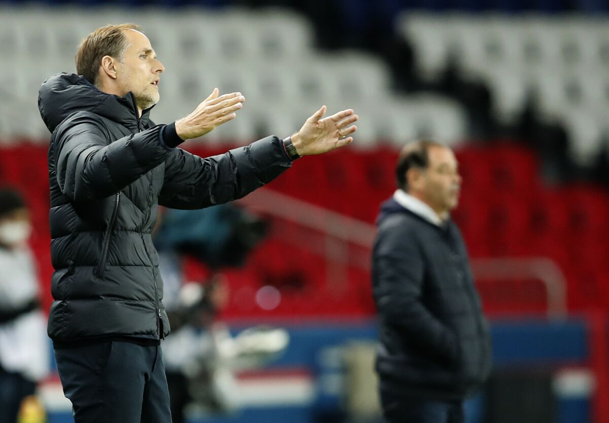PSG's head coach Thomas Tuchel gestures as he stands on the touchline during the French League One soccer match between Paris Saint-Germain and Angers at the Parc des Princes in Paris, France, Friday, Oct. 2, 2020. (AP Photo/Francois Mori)