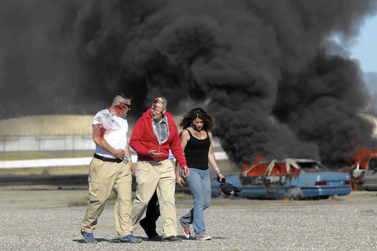 Volunteers portray injured passengers at Burbank Bob Hope Airport’s disaster drill.