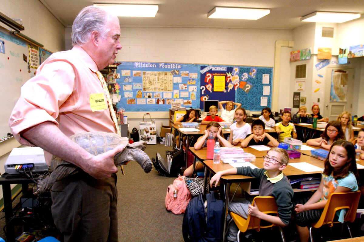 Veterinarian Woody Walker showed off his 70-year old pet tortoise after reading a book about the Galapagos Islands to fourth-grade students during the Community Read-In at La Cañada Elementary School in La Cañada Flintridge on Wednesday, March 2, 2016.
