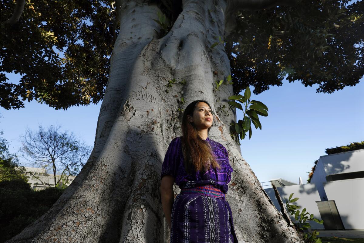 Alba Gonzalez stands before a large tree