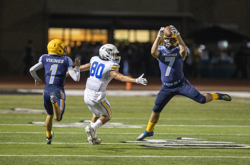 Marina's Cade Jackman intercepts a pass intended for Fountain Valley's Drew Reyes at Westminster High School on Friday.