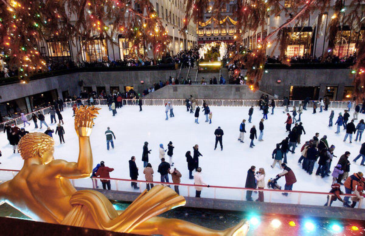 Lights twinkle and staters circle the Rockefeller Center ice skating rink. Rockefeller Center is one of many sites that On Location Tours will pass on a seasonal bus outings focusing on Manhattan holiday displays and film locations. This scene was shot in 2003.