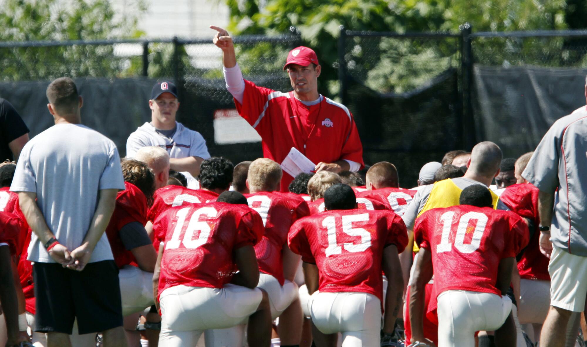 Then-Ohio State head coach Luke Fickell, center, addresses his team on Aug 16, 2011, in Columbus, Ohio. 