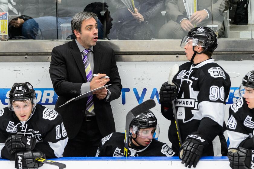 BLAINVILLE-BOISBRIAND, QC - OCTOBER 02: Head coach Joel Bouchard of the Blainville-Boisbriand Armada gives instructions to Kristian Pospisil #96 during the QMJHL game against the Charlottetown Islanders at the Centre d'Excellence Sports Rousseau on October 2, 2015 in Blainville-Boisbriand, Quebec, Canada. (Photo by Minas Panagiotakis/Getty Images)
