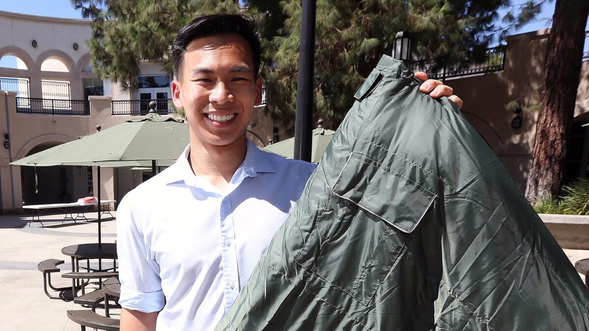 2016 Flintridge Prep graduate Vick Liu holds a TravlerPack, a sleeping bag for refugees.