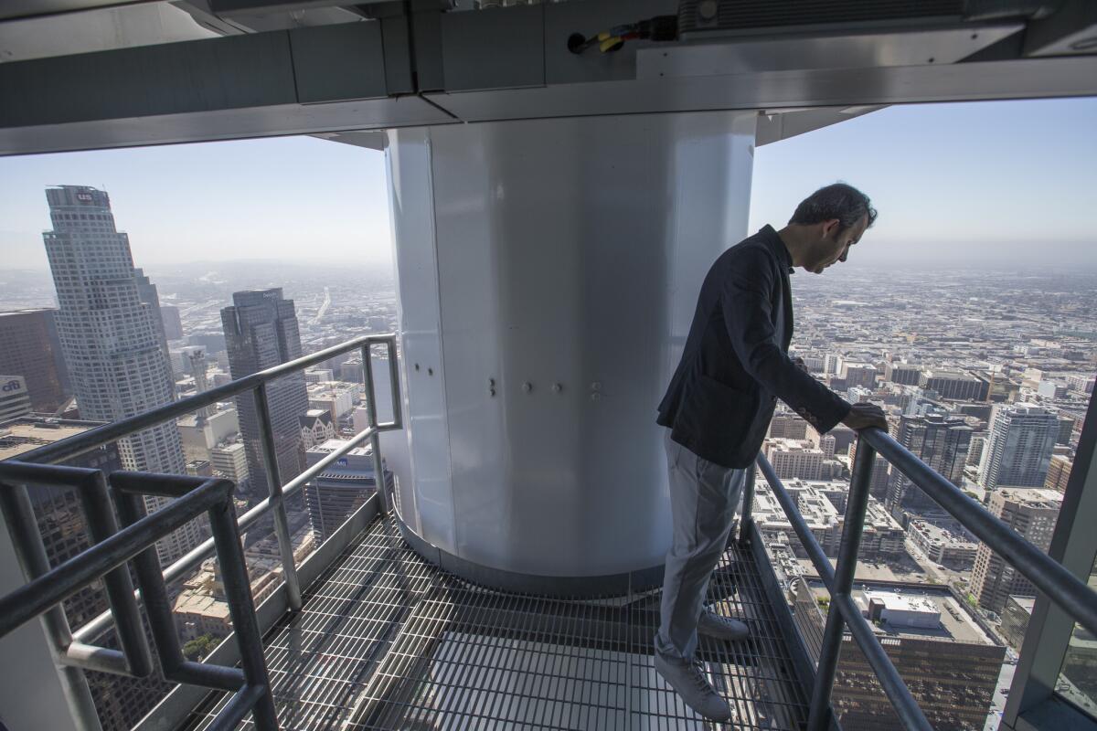 Brad Gwinn, StandardVision chief operations officer, looks out from inside the sail atop of the InterContinental Los Angeles bar on the 73rd floor of the Wilshire Grand Center. (Allen J. Schaben / Los Angeles Times)