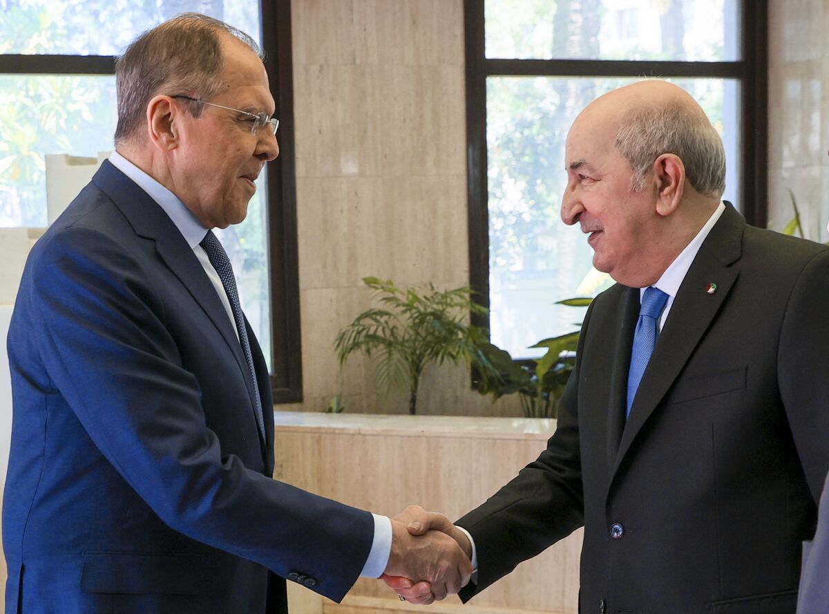 In this photo released by Russian Foreign Ministry Press Service, Algerian President Abdelmadjid Tebboune, right, greets Russian Foreign Minister Sergey Lavrov during their meeting at El Mouradia Palace, the official residence of the President, in Algiers, Algeria, on Tuesday, May 10, 2022. (Russian Foreign Ministry Press Service via AP)