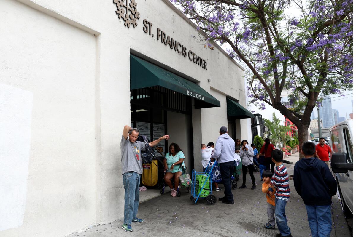 People wait in line at the food bank at the St. Francis Center.(Gary Coronado / Los Angeles Times)