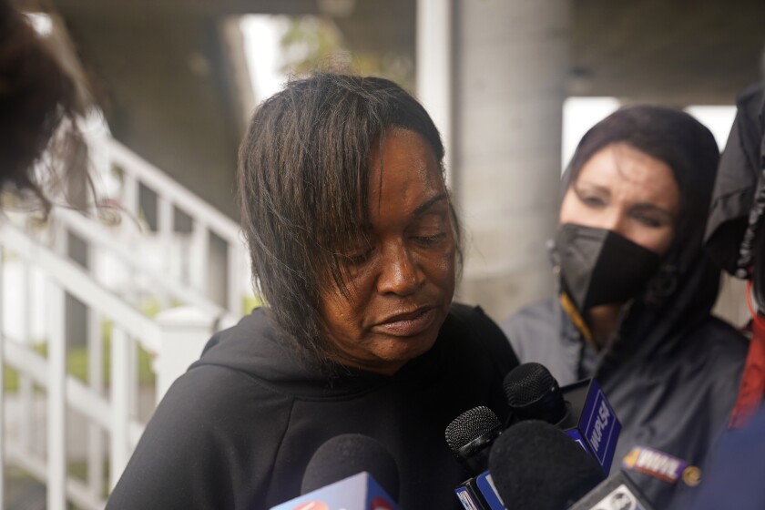 Dawn Saddler, sister of missing crewmember Gregory Walcott, talks to reporters as she leaves a briefing for family members by Coast Guard and NTSB officials in Port Fouchon, La., Friday, April 16, 2021. The Coast Guard has told families of missing workers that another body has been found from the lift boat capsized off the Louisiana coast and a coroner has confirmed that to a news outlet. (AP Photo/Gerald Herbert)