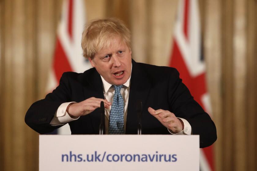 FILE - In this Tuesday, March 17, 2020 file photo British Prime Minister Boris Johnson gestures as he gives a press conference about the ongoing situation with the COVID-19 coronavirus outbreak inside 10 Downing Street in London. British Prime Minister Boris Johnson has been admitted to a hospital with the coronavirus. Johnson's office says he is being admitted for tests because he still has symptoms 10 days after testing positive for the virus.(AP Photo/Matt Dunham, File)